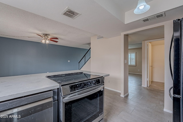 kitchen with visible vents, a textured ceiling, stainless steel appliances, and a ceiling fan