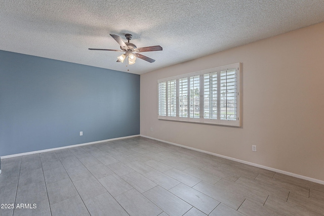 empty room with baseboards, a textured ceiling, and ceiling fan