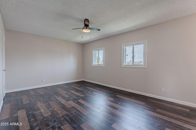 unfurnished room featuring ceiling fan, baseboards, a textured ceiling, and dark wood finished floors