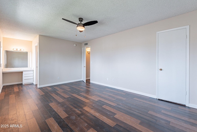 unfurnished bedroom featuring visible vents, baseboards, dark wood-type flooring, and a textured ceiling