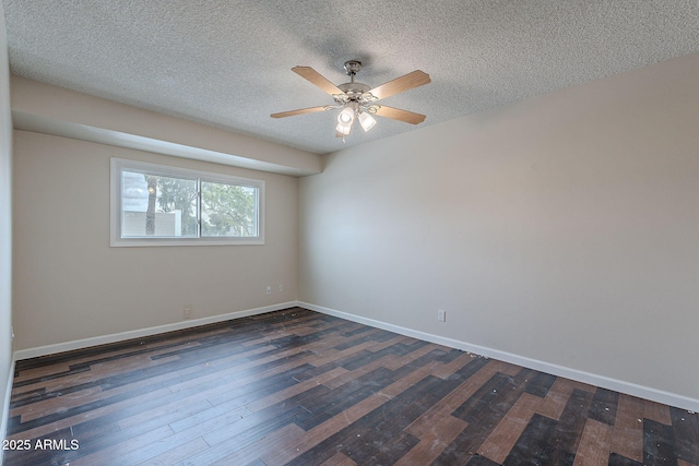 spare room with a textured ceiling, baseboards, a ceiling fan, and dark wood-style flooring