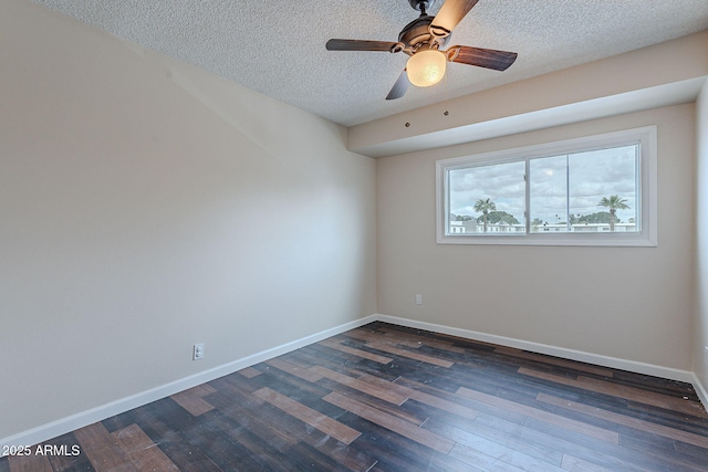 spare room with dark wood-style floors, a textured ceiling, baseboards, and a ceiling fan