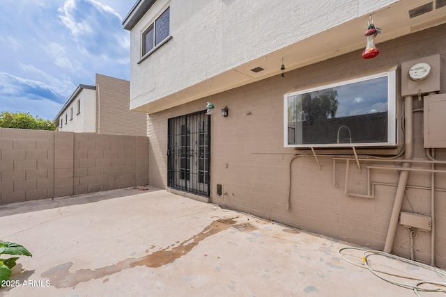 view of patio / terrace featuring visible vents and fence