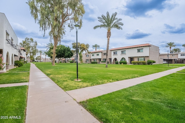 view of home's community featuring a residential view and a yard