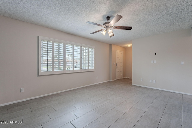 unfurnished room featuring a textured ceiling, baseboards, and ceiling fan