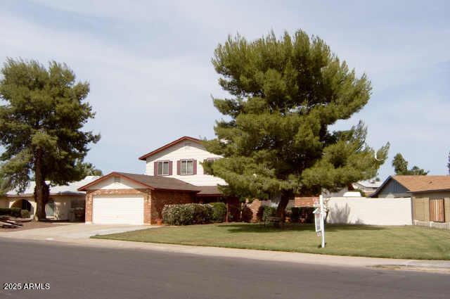 view of front of property with a garage and a front lawn