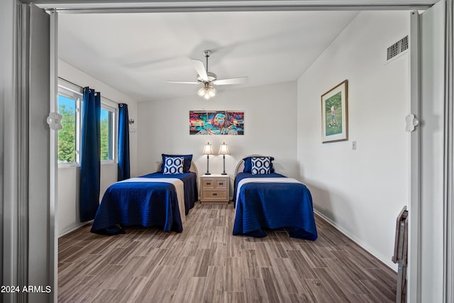 bedroom featuring vaulted ceiling, ceiling fan, and hardwood / wood-style flooring