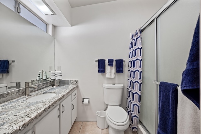 bathroom with vanity, tile floors, and toilet