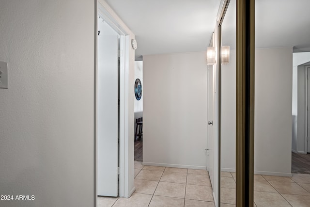 corridor featuring light tile floors