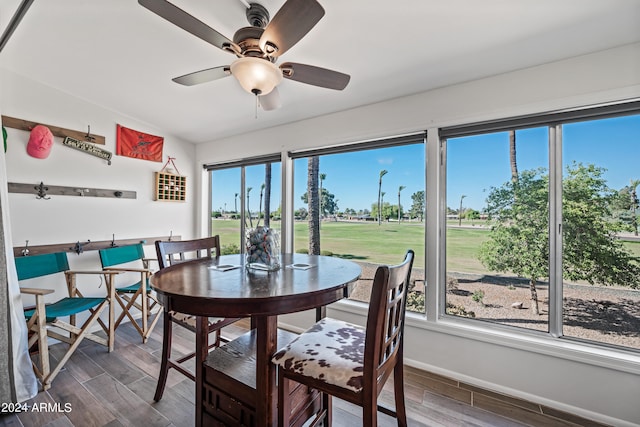 dining area featuring ceiling fan, plenty of natural light, and dark hardwood / wood-style flooring