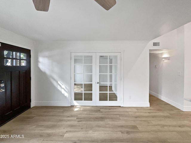 entryway with visible vents, french doors, a ceiling fan, and wood finished floors