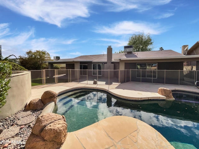 view of pool with grilling area, a fenced in pool, a patio, and fence