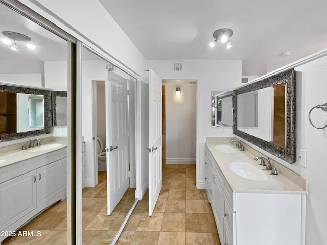 full bathroom with double vanity, visible vents, and a sink