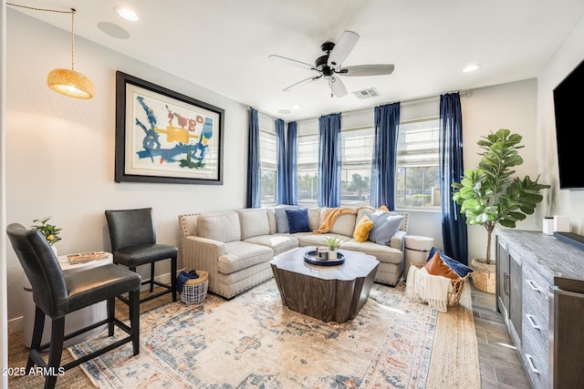 living area featuring recessed lighting, wood finished floors, visible vents, and a ceiling fan