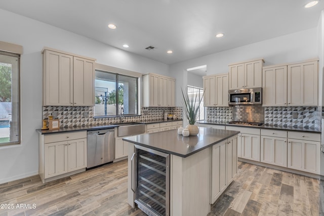 3806 E Taurus Pl, Chandler, AZ 85249 - kitchen featuring wine cooler, appliances with stainless steel finishes, a sink, dark countertops, and decorative backsplash