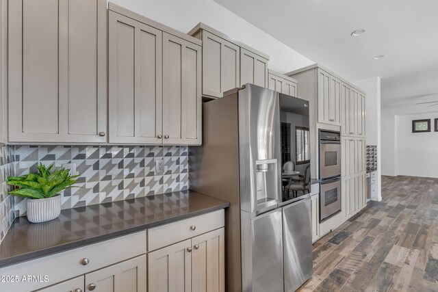 3806 E Taurus Pl, Chandler, AZ 85249 - kitchen featuring stainless steel appliances, dark countertops, dark wood finished floors, tasteful backsplash, and recessed lighting