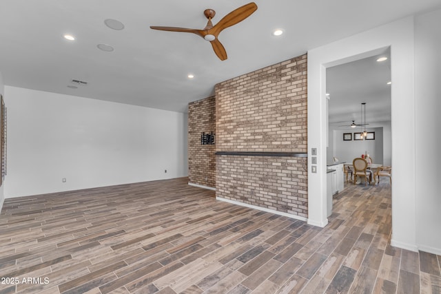 3806 E Taurus Pl, Chandler, AZ 85249 - living area with a ceiling fan, wood finished floors, recessed lighting, and brick wall