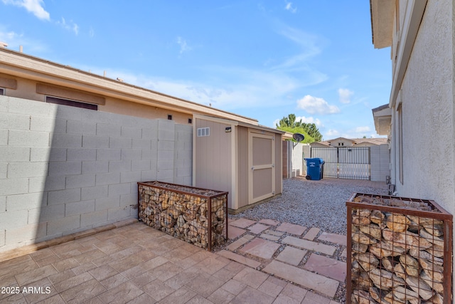 3806 E Taurus Pl, Chandler, AZ 85249 - view of patio featuring a shed, a fenced backyard, an outbuilding, and a gate
