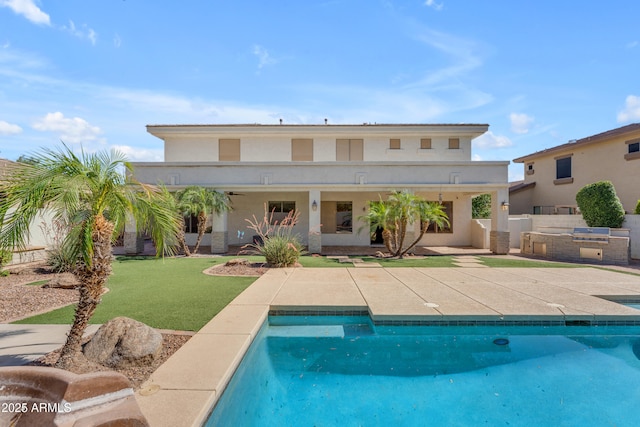 3806 E Taurus Pl, Chandler, AZ 85249 - back of property with exterior kitchen, a patio area, an outdoor pool, and stucco siding
