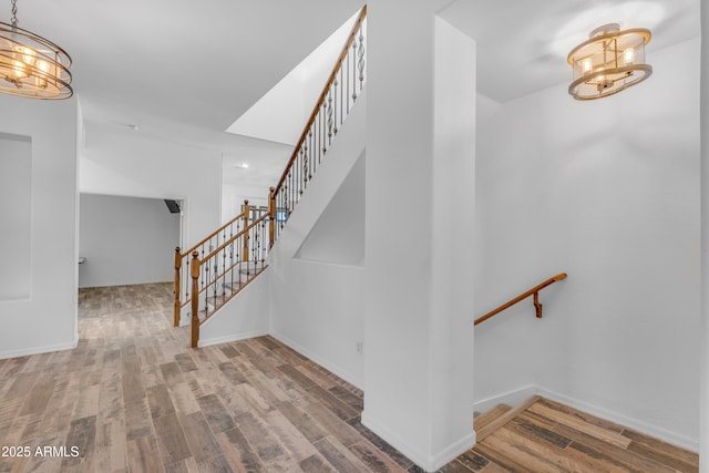 3806 E Taurus Pl, Chandler, AZ 85249 - stairway featuring a chandelier, wood finished floors, and baseboards
