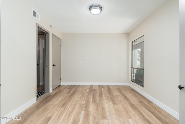 5221 N 24th St Unit 103, Phoenix, AZ 85016 - unfurnished room with light wood-style flooring and baseboards
