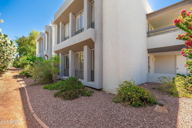5221 N 24th St Unit 103, Phoenix, AZ 85016 - view of side of property with stucco siding and a balcony