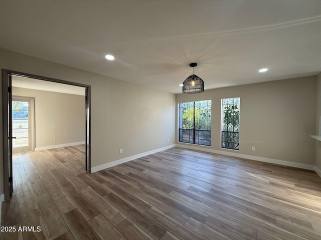 unfurnished dining area with baseboards, recessed lighting, and dark wood-style floors