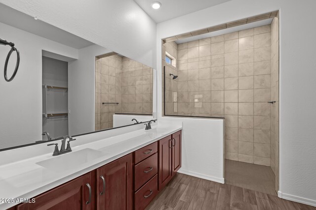 12308 W Parkway Ln, Avondale, AZ 85323 - bathroom with a walk in shower, wood finished floors, and double vanity