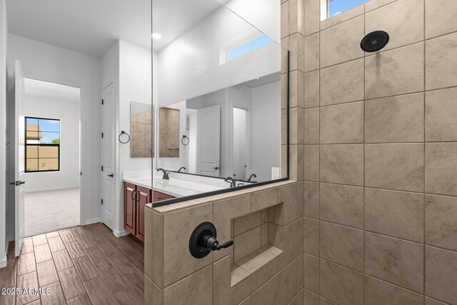 12308 W Parkway Ln, Avondale, AZ 85323 - bathroom with tiled shower, double vanity, and baseboards