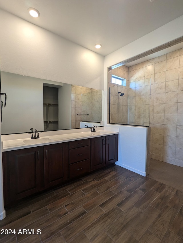 bathroom featuring tile walls, vanity, and a shower