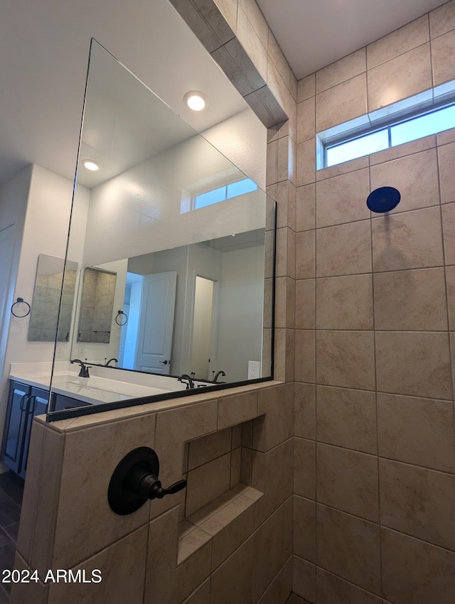 bathroom with vanity and tiled shower