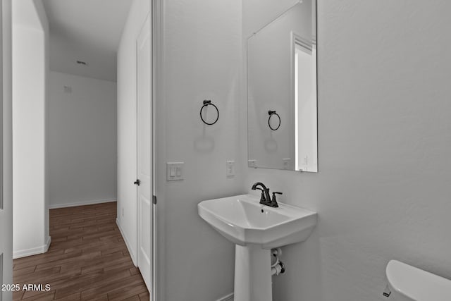 12308 W Parkway Ln, Avondale, AZ 85323 - bathroom with wood finished floors, toilet, and baseboards