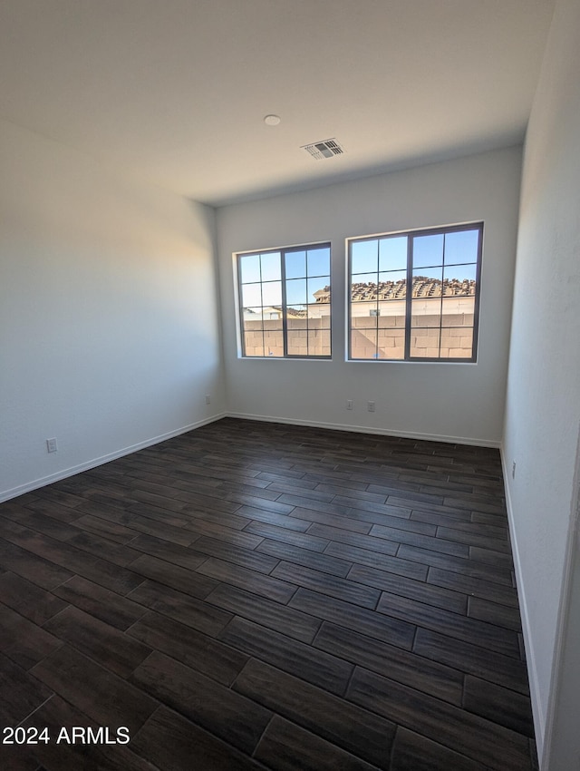 spare room featuring dark hardwood / wood-style flooring