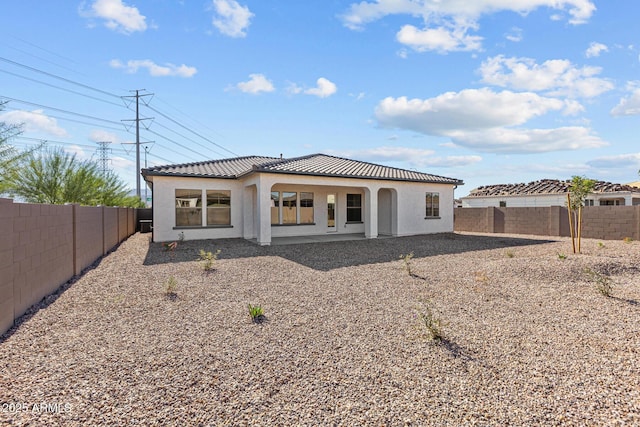 12308 W Parkway Ln, Avondale, AZ 85323 - rear view of house featuring a tiled roof, a fenced backyard, stucco siding, and a patio