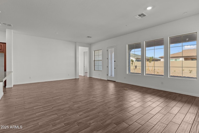 12308 W Parkway Ln, Avondale, AZ 85323 - unfurnished living room featuring dark wood-style flooring and baseboards