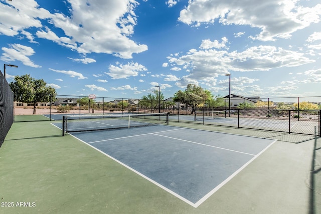 view of sport court featuring fence