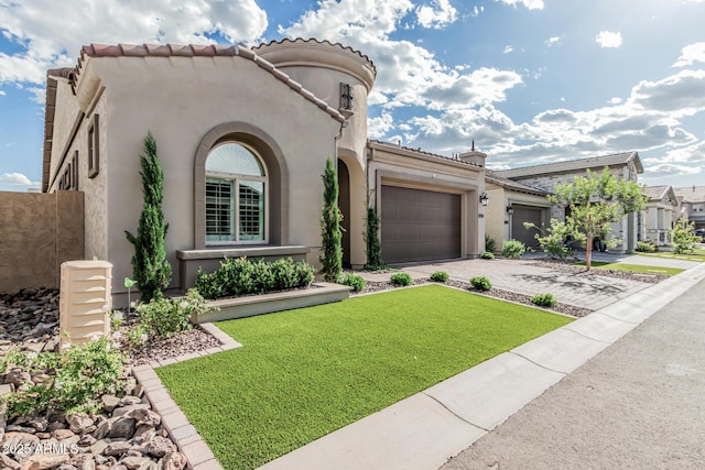 mediterranean / spanish home featuring an attached garage, a front lawn, stucco siding, a tiled roof, and driveway
