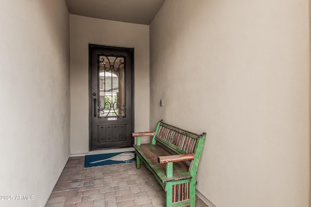 entrance to property featuring stucco siding