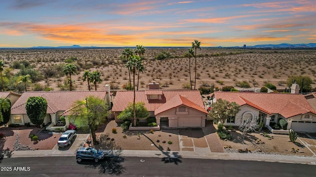 drone / aerial view featuring view of desert and a mountain view