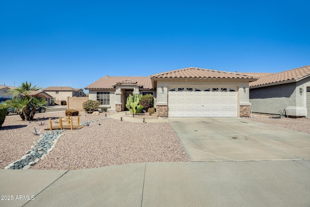 mediterranean / spanish-style home featuring a garage, stone siding, driveway, and stucco siding