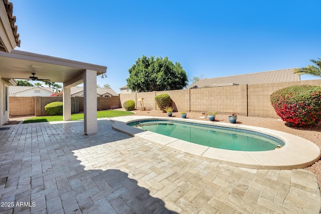 view of swimming pool featuring a fenced backyard, a fenced in pool, and a patio