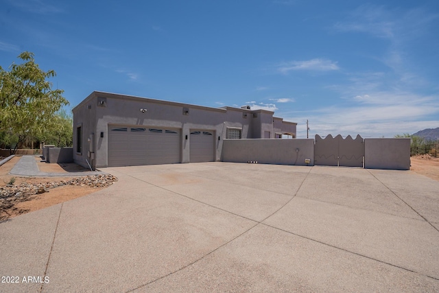 view of side of property featuring an attached garage, concrete driveway, and stucco siding