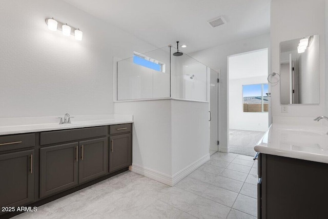 bathroom featuring a walk in shower, visible vents, vanity, and baseboards