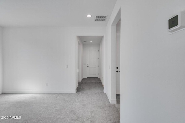 corridor featuring carpet, visible vents, baseboards, and recessed lighting