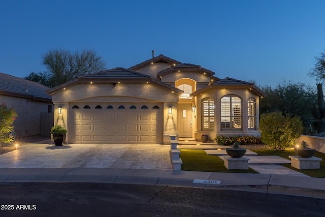 4605 E Swilling Rd, Phoenix, AZ 85050 - mediterranean / spanish-style house with stucco siding, driveway, a garage, and a tile roof