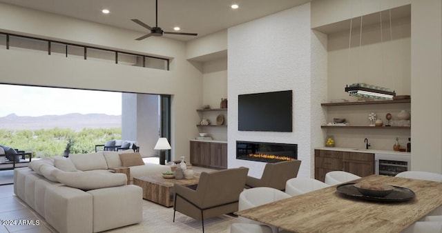 living room with sink, ceiling fan, a mountain view, and wine cooler