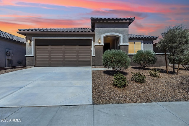 25876 N 162nd Dr, Surprise, AZ 85387 - mediterranean / spanish house featuring an attached garage, a tile roof, driveway, and stucco siding