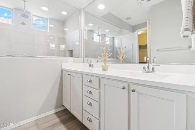 25876 N 162nd Dr, Surprise, AZ 85387 - bathroom with double vanity, a tile shower, wood finished floors, and recessed lighting