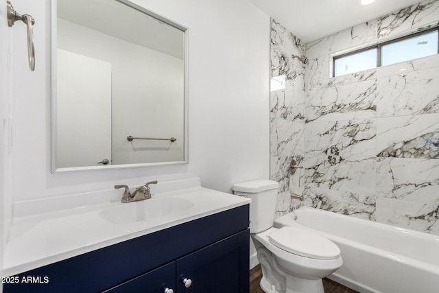 bathroom featuring bathing tub / shower combination, vanity, and toilet