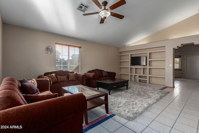 living room featuring built in shelves, vaulted ceiling, ceiling fan, and light tile patterned flooring